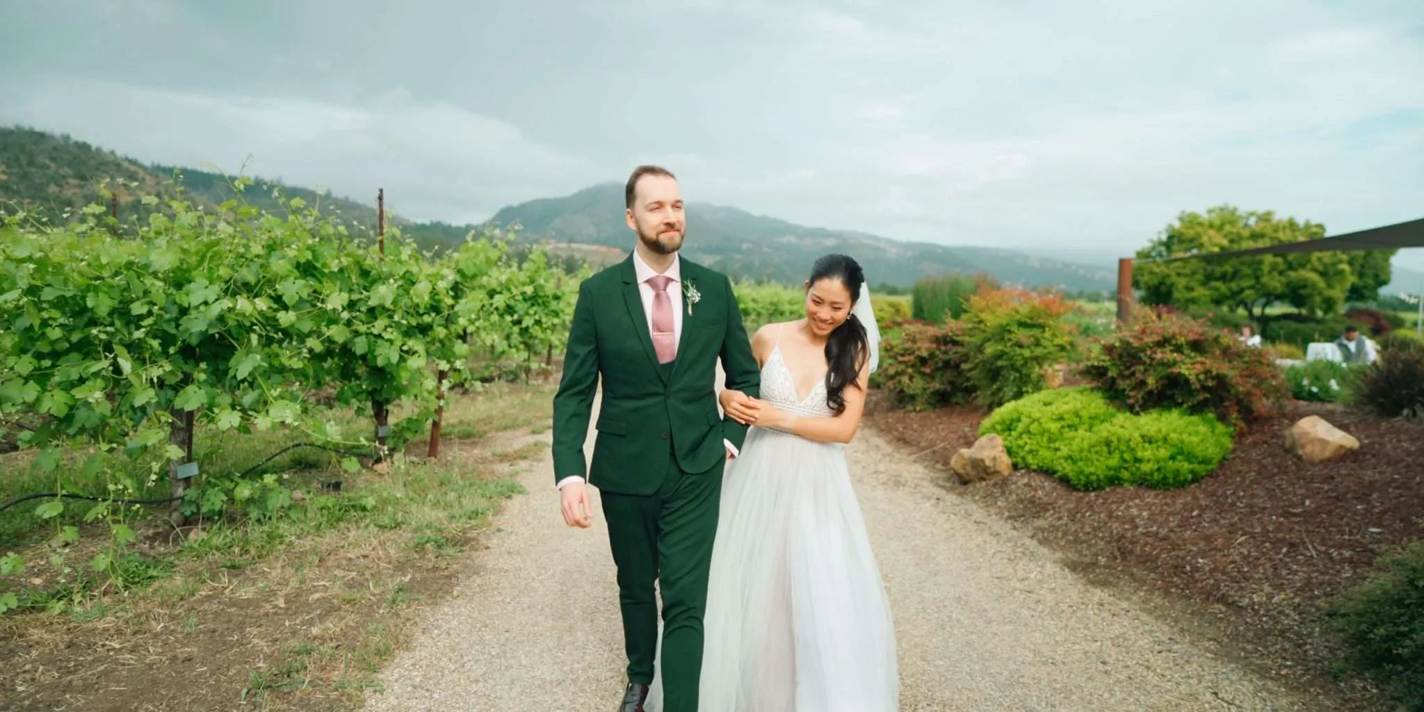 Joyful newly wed couple sharing a romantic stroll by the vineyard